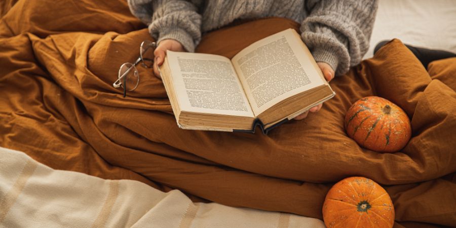 Fall Reading Reading a book in a cozy blanket giving fall vibes